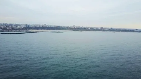 Flying over open sea towards the shore 스톡 동영상 74115503