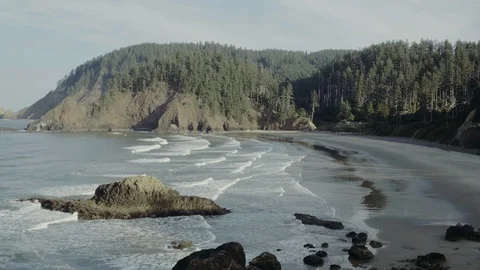 Flying Over Oregon Coast Beach With Crashing Waves and Rock Formations Stock Footage 102802171