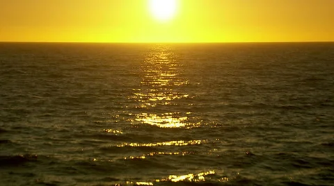Flying over Pacific Ocean at sunset Stock Footage