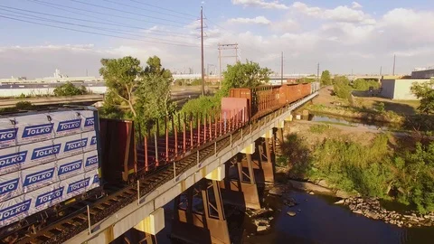 Flying over Parked train on a bridge Color Corrected Stock Footage 98845016