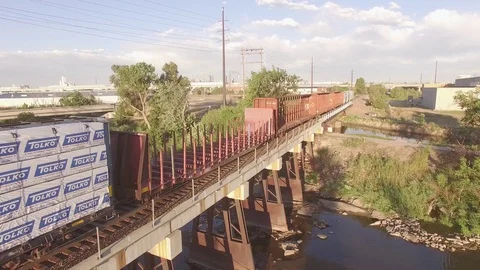 Flying over Parked train on a bridge Stock Footage 98845017