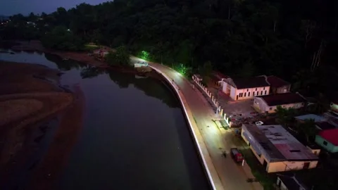 Flying over the parrot river at Santo Antonio city at night with a motorcycle Stock-Footage 312684560