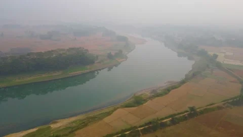 Flying over  a patchwork of plowed fields in rural countryside on the Stock Footage 234482381