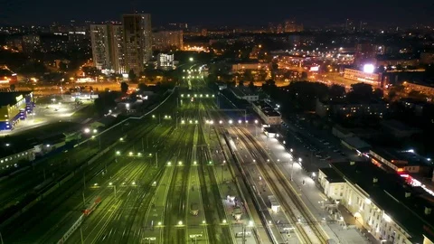 Flying over the paths of the night the train station , Yekaterinburg, Russia Stock Footage 113529356