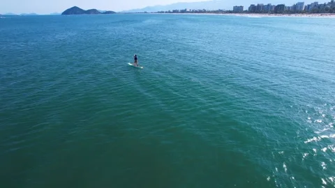 Flying over a person doing stand up paddle on the beach of Riviera de So Lo.. Stock Footage 256794513