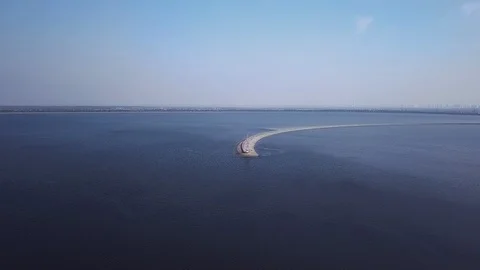 Flying over the pier with an abandoned lighthouse with flocks of seagulls Video stock 126701441