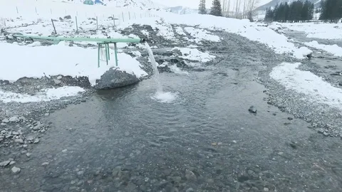 Flying over a pipe from which pouring clean water.  Spring water Stock Footage 109601964