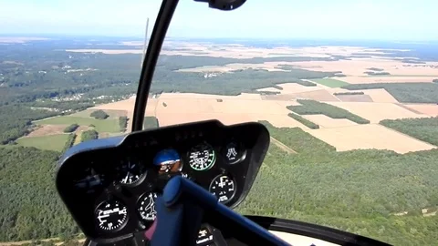 Flying over plains and forests, seen from helicopter cockpit Видео 74017541