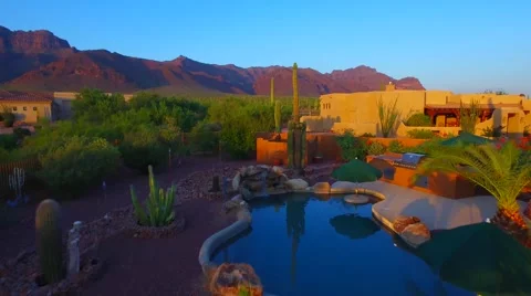 Flying over plams tree pool and saguaro Superstition mountain home AZ.mp4 Stock Footage 54254196