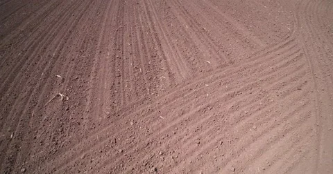 Flying over the plowed field Stock Footage 66879448