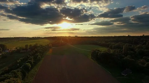 Flying over the plowed field at sunset Video stock 84183199