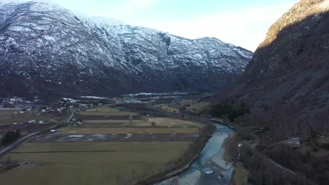 Flying over popular Laerdal salmon river during winter off season with low Stock Footage 182779019