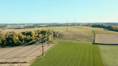 Flying over power lines in a field in autumn Vídeos de archivo 146629255