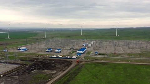 Flying over a power plant surrounded by windmills. Stock Footage 229776154