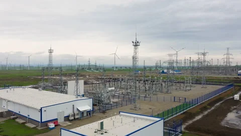Flying over a power plant surrounded by windmills. Stock Footage 230237607