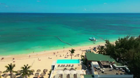 Flying over a Punta Cana beach hotel featuring a stunning rooftop pool Stock Footage 305795142