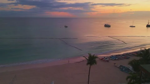 Flying over a Punta Cana beach hotel featuring stunning rooftop pool at sunrise Stock Footage 305807025