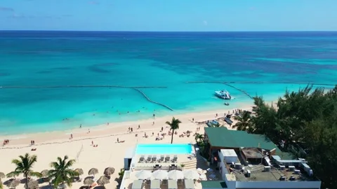 Flying over a Punta Cana beach hotel featuring a stunning rooftop pool Video stock 308118325