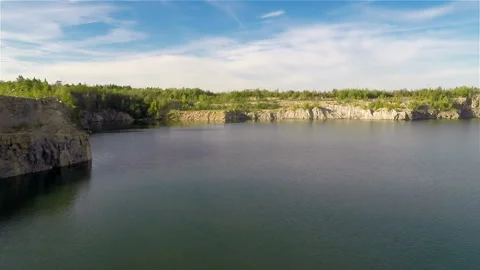 Flying over quarry lake Stock Footage 100662411