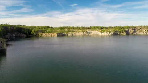 Flying over quarry lake Stock Footage 100662448