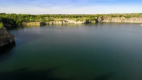 Flying over quarry lake Stock Footage 100662556