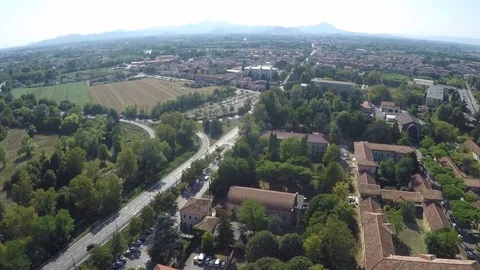 Flying over a quiet street, light traffic, between fields and city, Stock-Footage 72265624