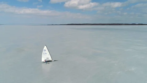 Flying over a racing DN-class ice boat on a sunny day Stock Footage 88201107
