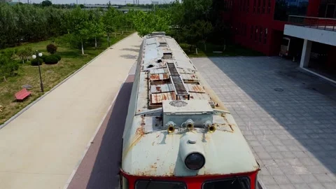 Flying over red antique ancient train locomotive in BJTU, Weihai campus Stock Footage 234181042