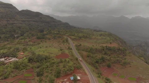 Flying over a red bus on a hill road Stock Footage 111694617