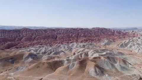 Flying over the red, colorful, rainbow mountains, covered with unique patterns Stock Footage 105804811
