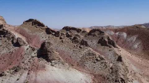 Flying over the red, colorful, rainbow mountains, covered with unique patterns Stock Footage 105804889