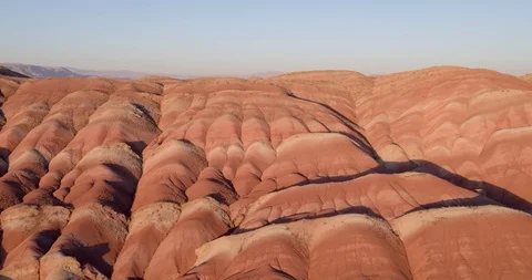 Flying over the red, colorful, rainbow mountains, covered with unique patterns Stock Footage 105808751