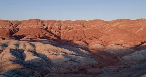 Flying over the red, colorful, rainbow mountains, covered with unique patterns Stock Footage 105808769