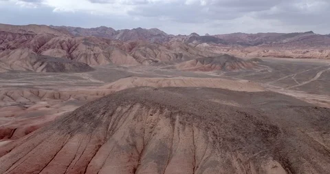 Flying over the red, colorful, rainbow mountains, covered with unique patterns Stock Footage 105845345