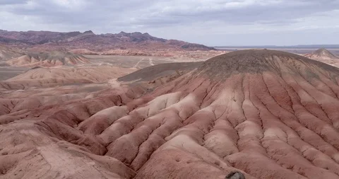 Flying over the red, colorful, rainbow mountains, covered with unique patterns Stock Footage 105845388