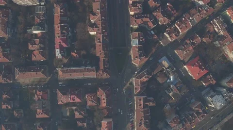 Flying over the red-tiled rooftops of the old European city. Light haze Stock Footage 58424088