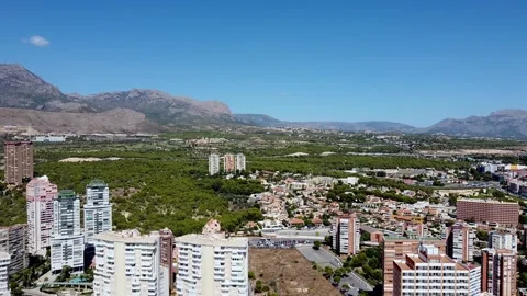 Flying over a residential area surrounded by mountains Video stock 152487587