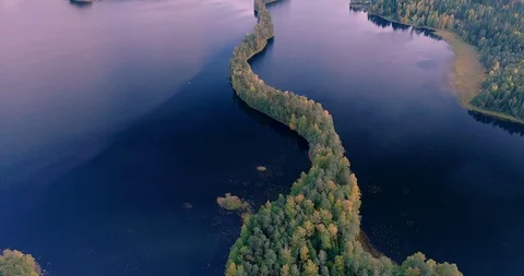 Flying over a ridge splitting the lake in Liesijriv forest, Finland Stock Footage 98762849