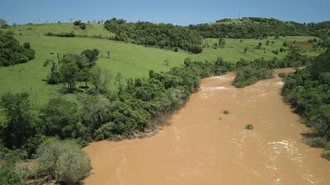 Flying over a river amid green fields and trees. 4K. Drone. Aerial. Stock Footage 233219606