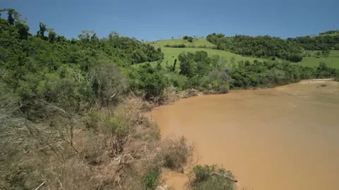 Flying over a river amid green fields and trees. 4K. Drone. Aerial. Stock Footage 233219622
