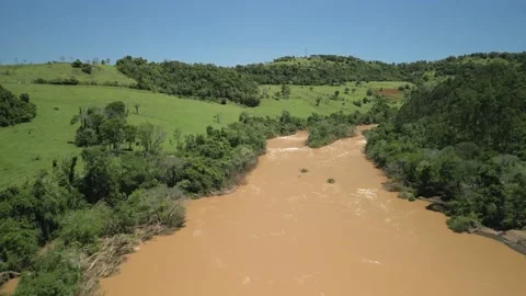 Flying over a river amid green fields and trees. 4K. Drone. Aerial. Stock Footage 233219624