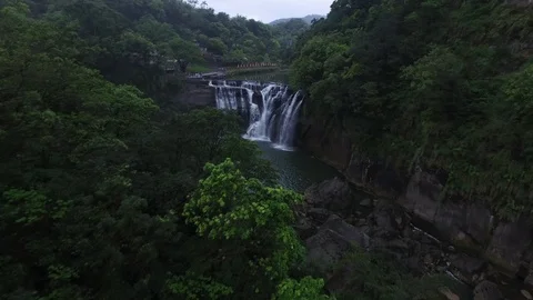 Flying over a river and forest towards a waterfall Stock Footage 85813834