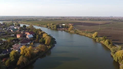 Flying over a river and a small European village at sunset. The nature of t.. Stock Footage 266904361