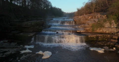 Flying over a river and waterfall Video stock 307303762