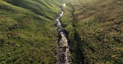 Flying over a river in the bottom of valley Stock Footage 335212002