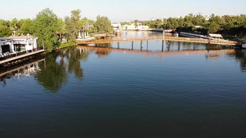 Flying over river with bridge and resort hotel territory in Belek Stock Footage 172359111