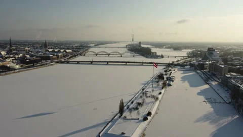 Flying over a river with a drone during a sunny snowy day Stock Footage 147031438