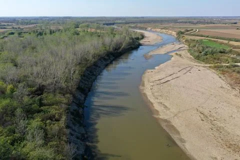Flying over a river flowing on a plain aerial view Stock Photos