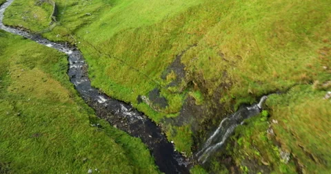Flying over a river in green valley Stock Footage 312364599