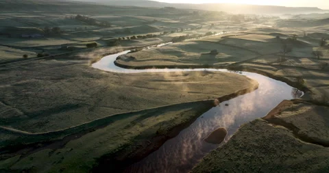 Flying over a river in a misty valley Stock Footage 205002835